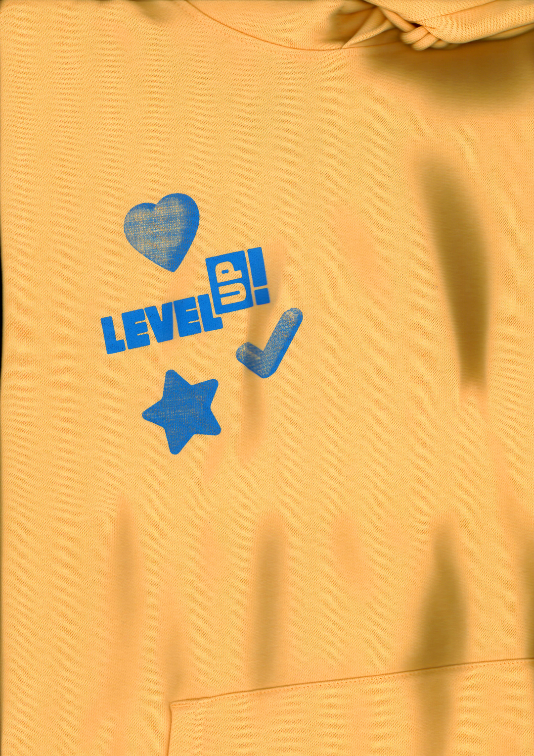 Yellow hoodie with the LevelUP! logo printed on it in blue.